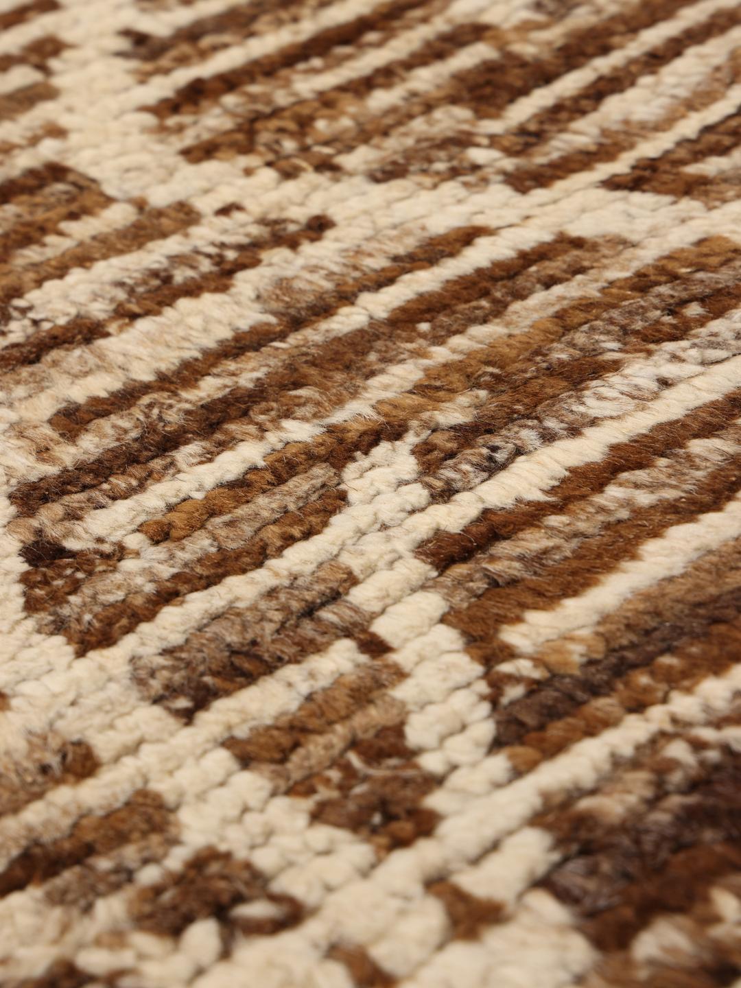 Hand-knotted rug from the Middle East with a geometric pattern in brown and beige tones.
