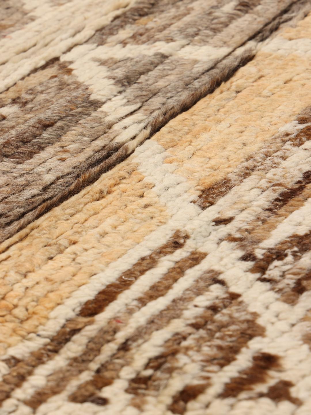 Hand-knotted rug from the Middle East with a geometric pattern in brown and beige tones.