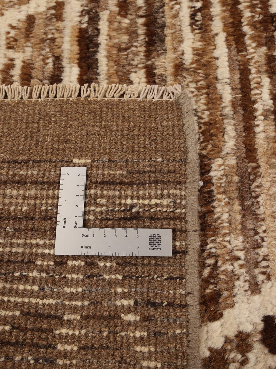 Hand-knotted rug from the Middle East with a geometric pattern in brown and beige tones.