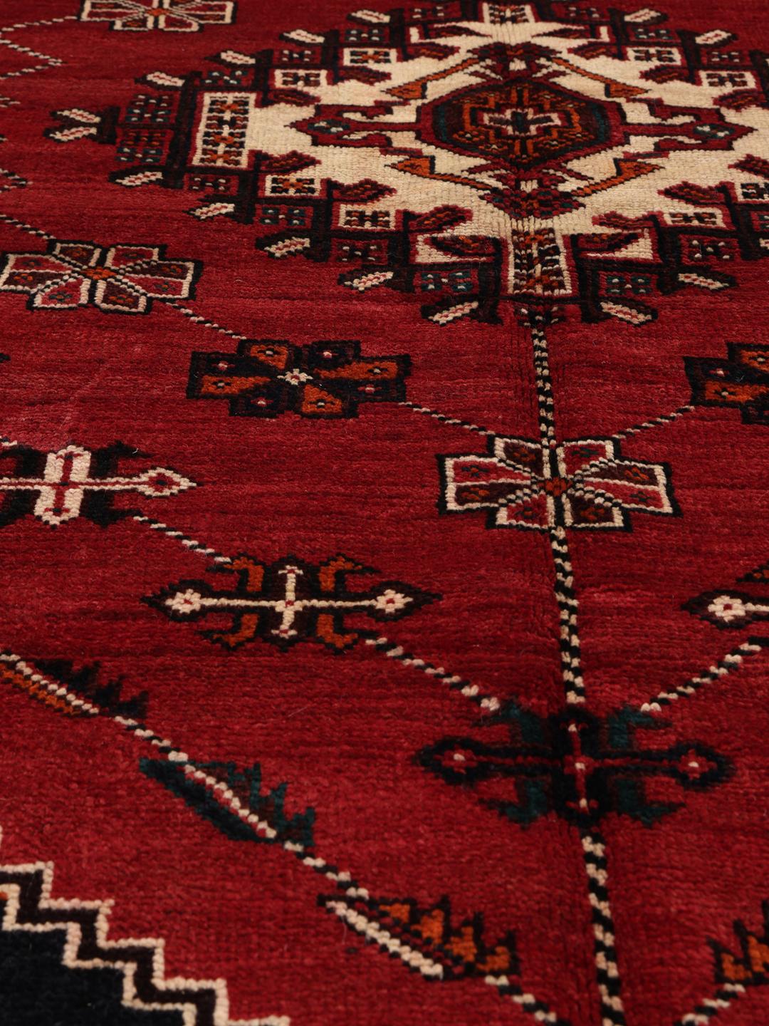 Hand-knotted Shiraz rug with geometric patterns in red and black