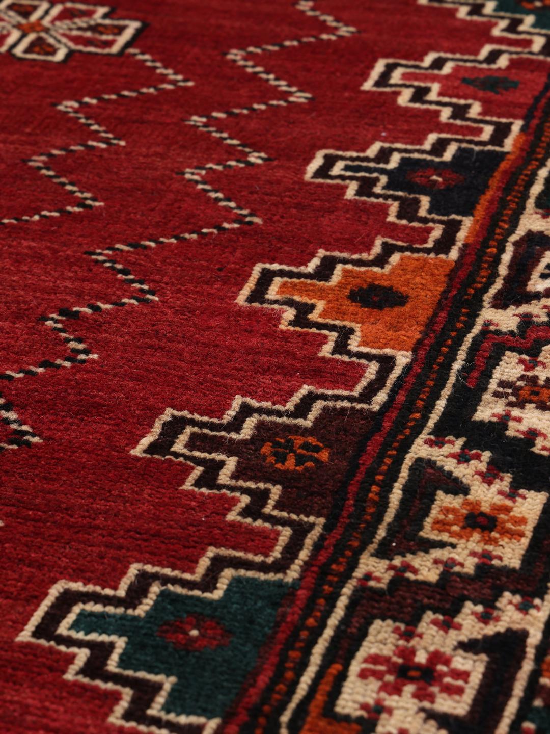 Hand-knotted Shiraz rug with geometric patterns in red and black