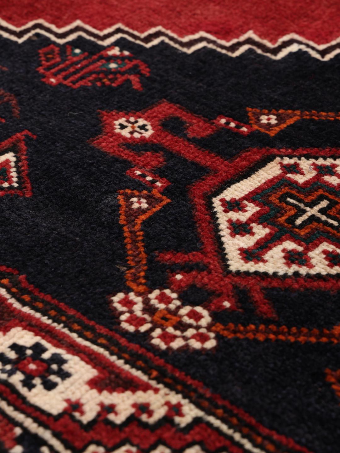 Hand-knotted Shiraz rug with geometric patterns in red and black