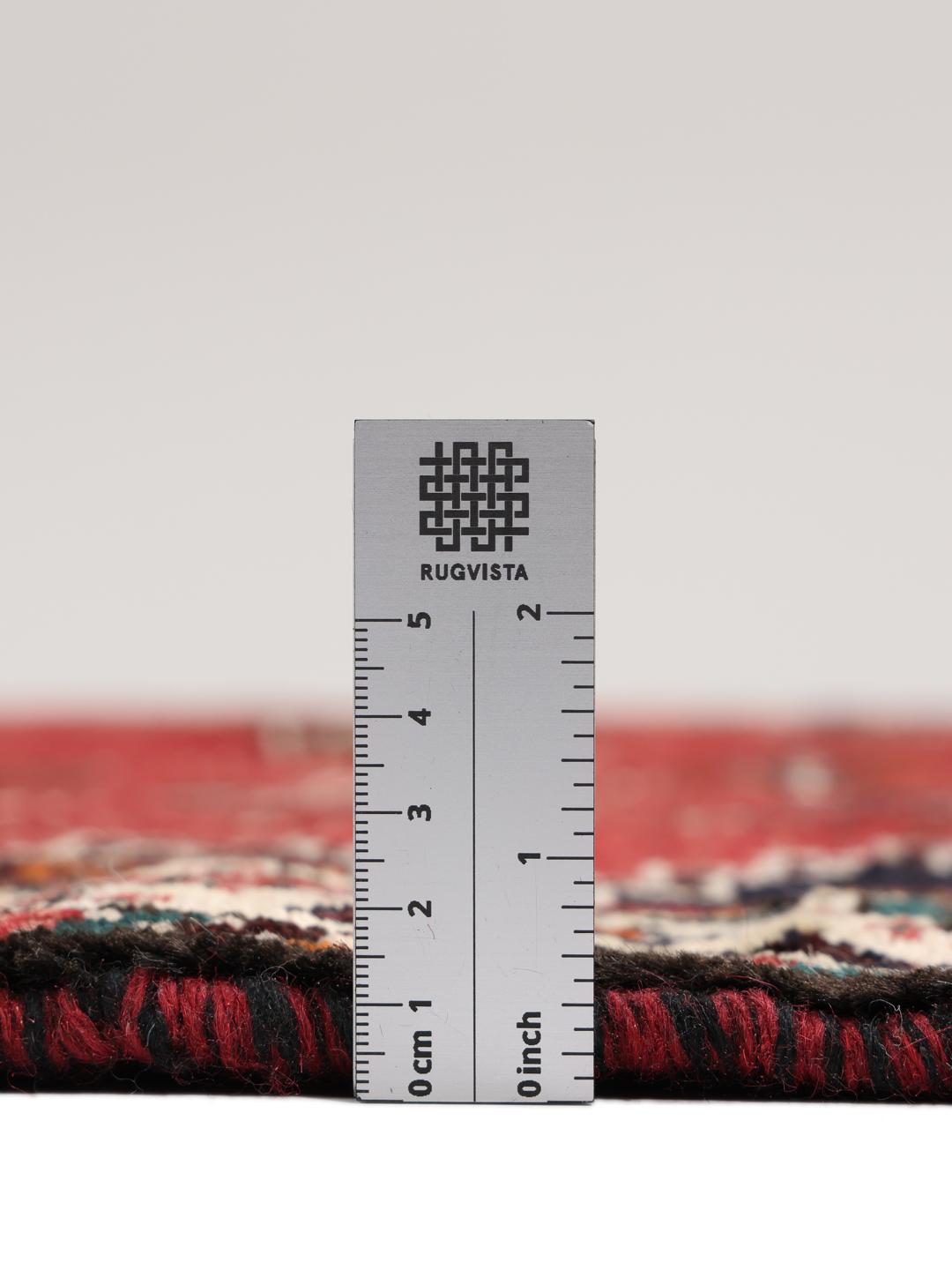 Hand-knotted Shiraz rug with geometric patterns in red and black