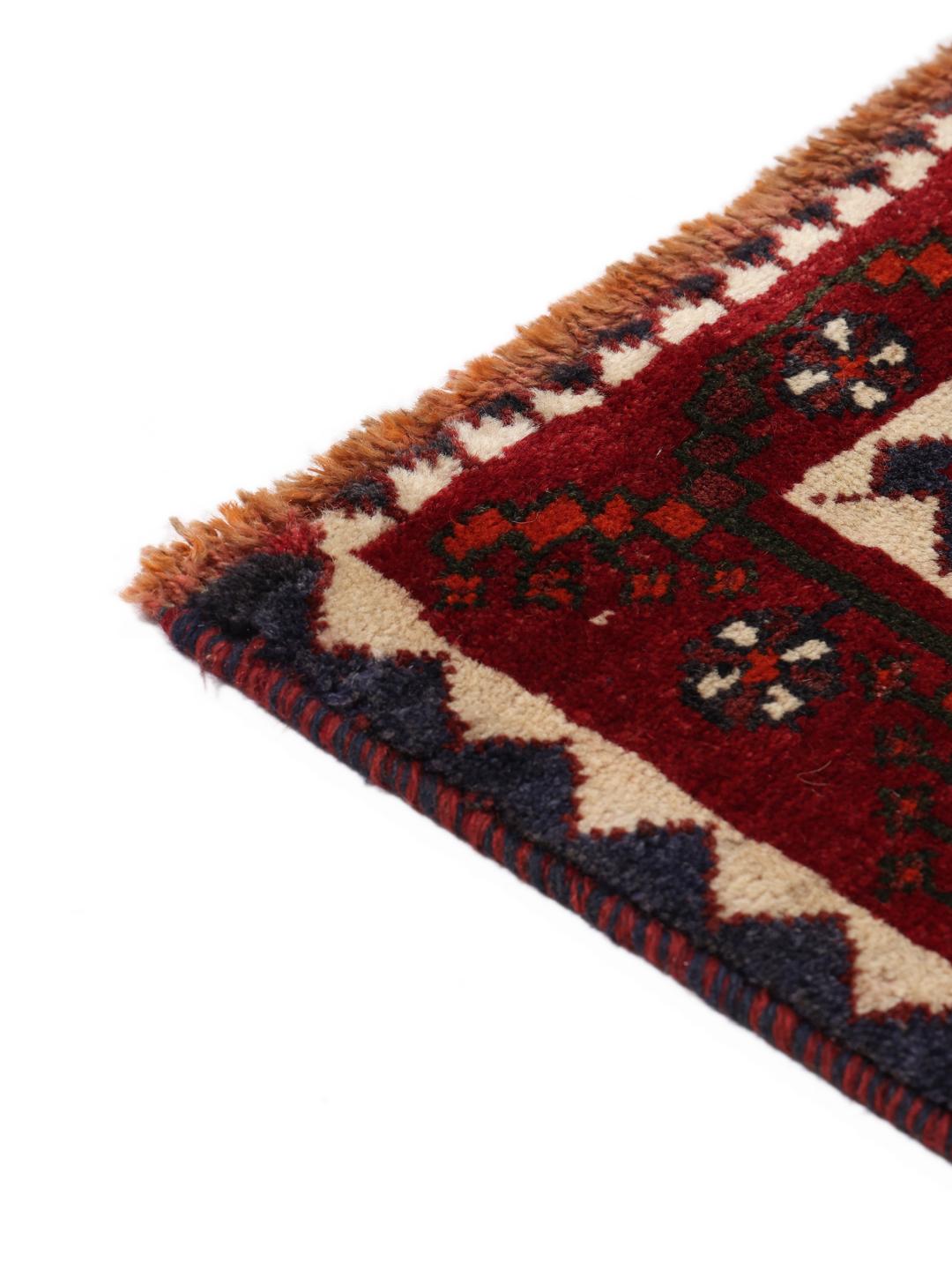 Hand-knotted Shiraz rug from the Middle East in deep red and black tones