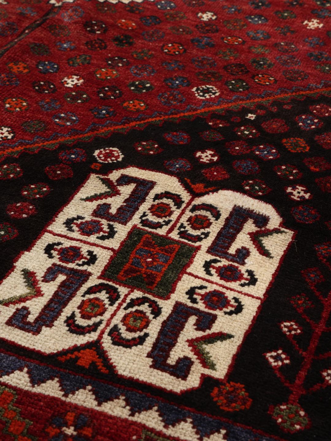 Hand-knotted Shiraz rug from the Middle East in deep red and black tones