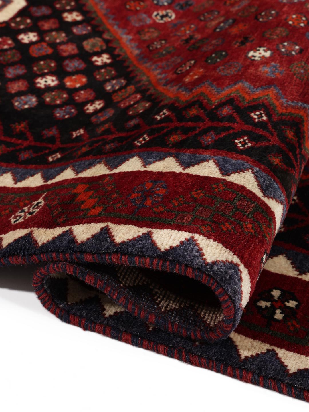Hand-knotted Shiraz rug from the Middle East in deep red and black tones