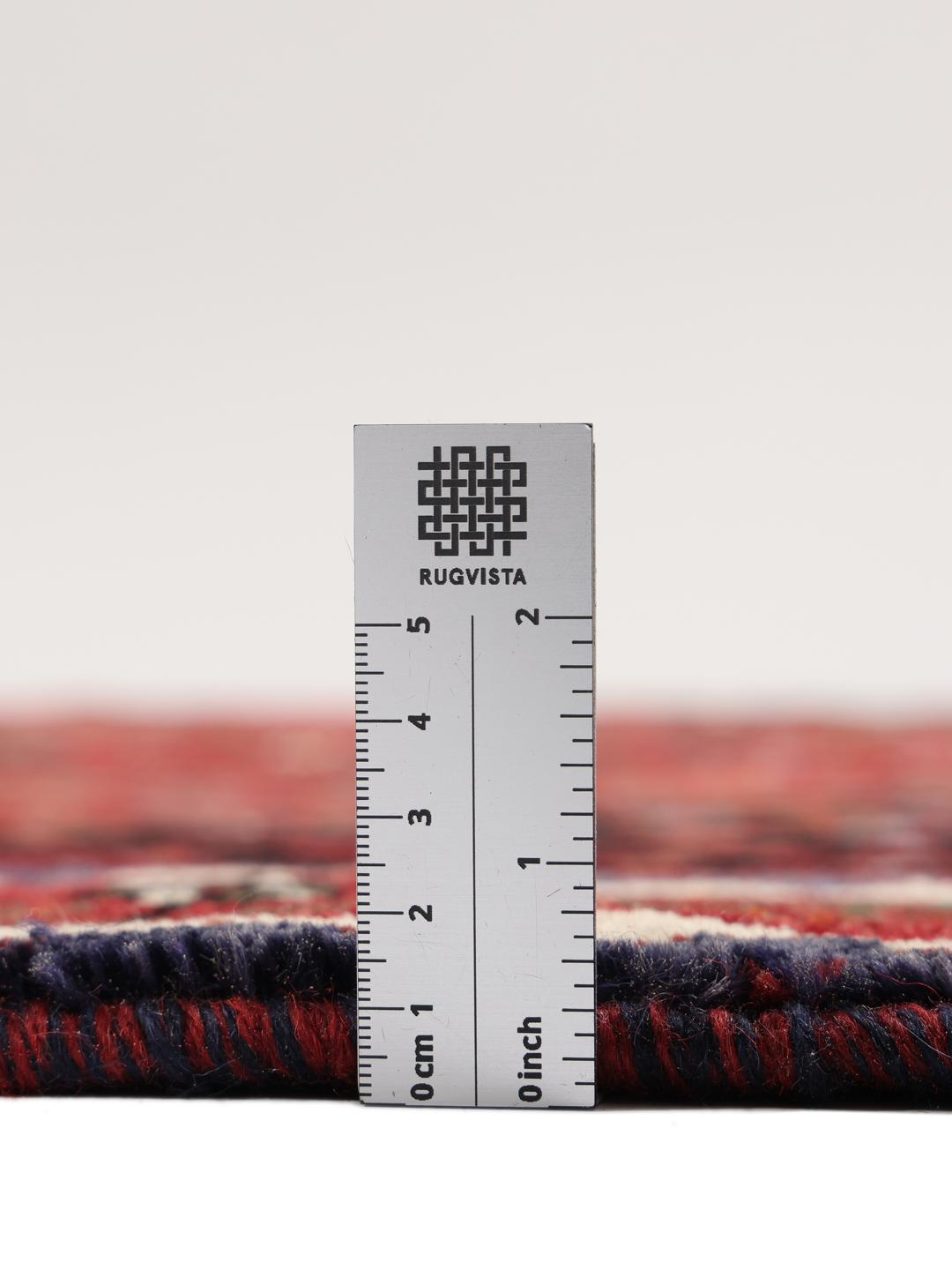 Hand-knotted Shiraz rug from the Middle East in deep red and black tones
