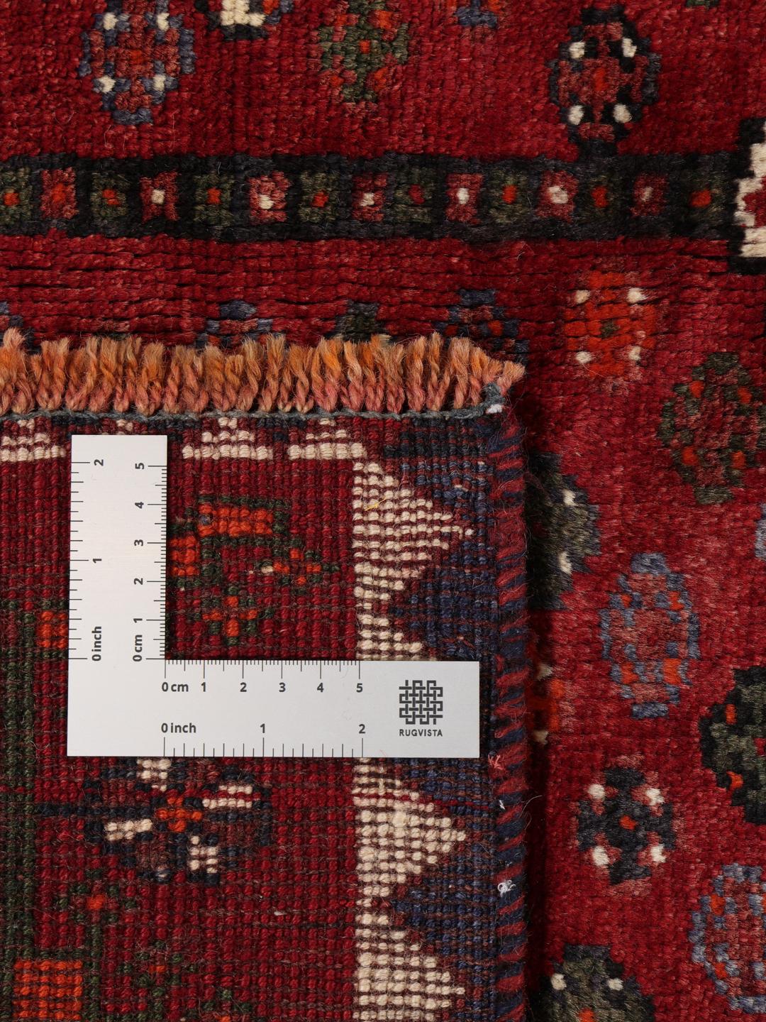 Hand-knotted Shiraz rug from the Middle East in deep red and black tones