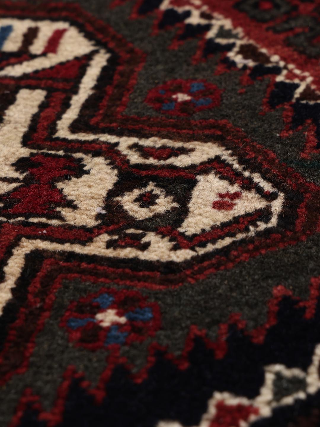 Hand-knotted Afshar Shahre Babak rug with geometric patterns in red and dark tones