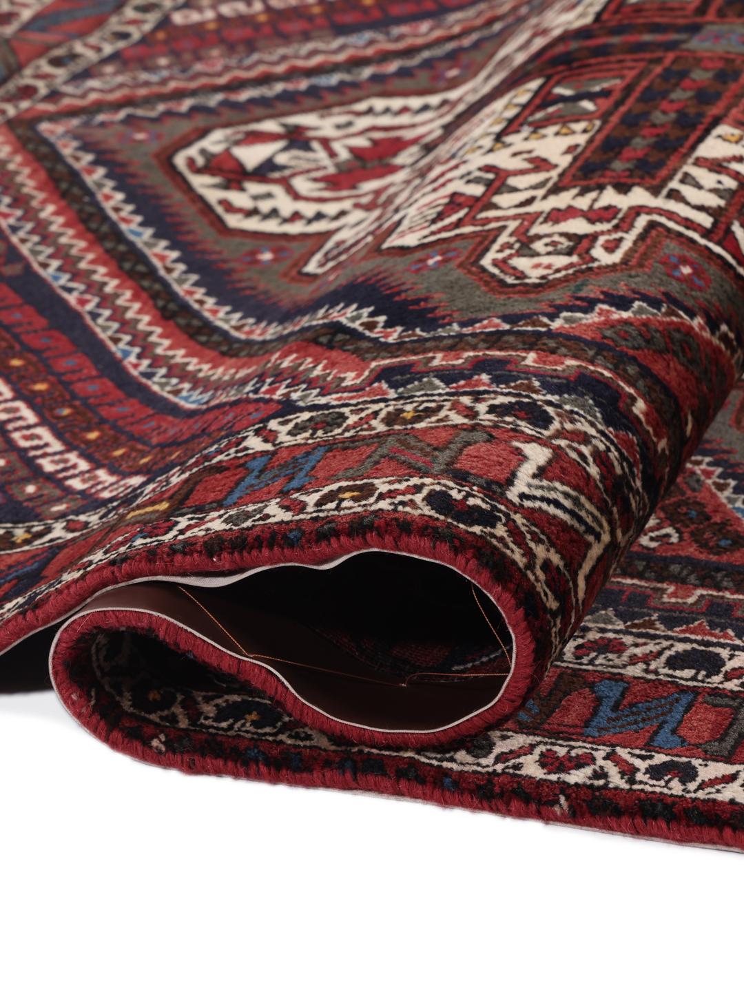Hand-knotted Afshar Shahre Babak rug with geometric patterns in red and dark tones