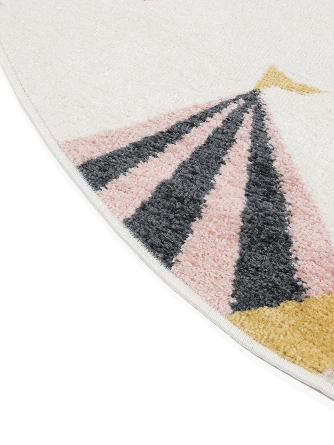 Tapis rond rose et blanc cassé avec un motif de cirque ludique