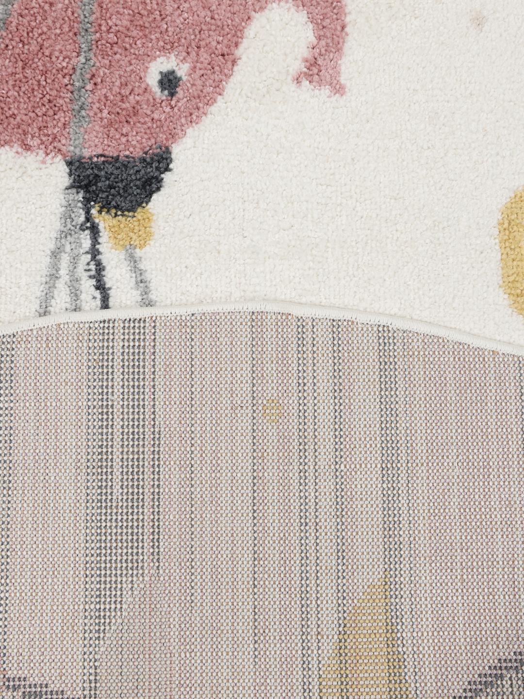 Tapis rond rose et blanc cassé avec un motif de cirque ludique