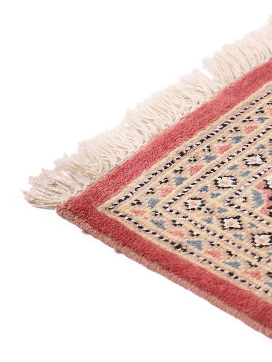 A hand-knotted red Pakistan Bokhara 2ply rug with geometric motifs