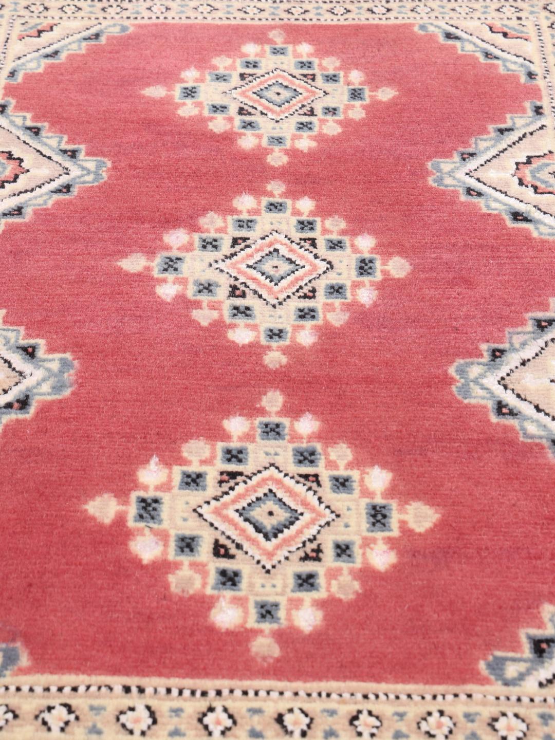 A hand-knotted red Pakistan Bokhara 2ply rug with geometric motifs