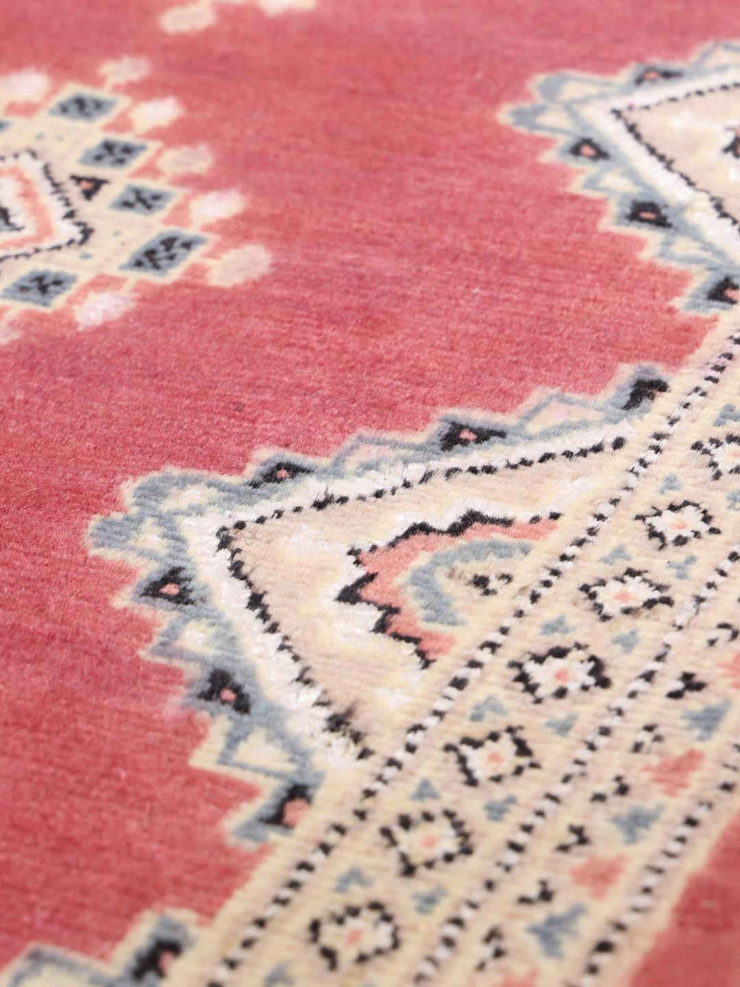 A hand-knotted red Pakistan Bokhara 2ply rug with geometric motifs