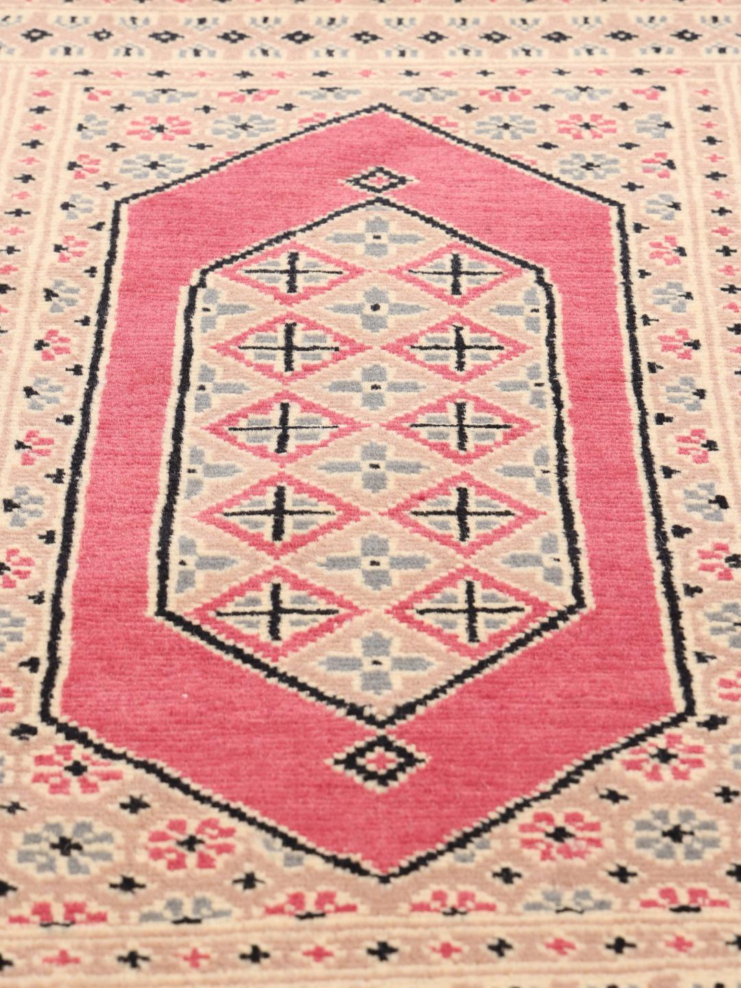 A set of two hand-knotted Pakistan Bokhara Wool rugs in red and beige tones.