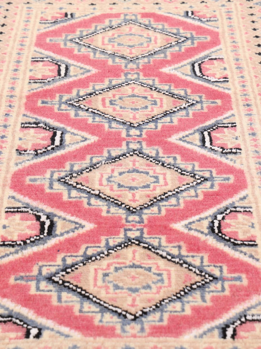 A set of two hand-knotted Pakistan Bokhara Wool rugs in red and beige tones.