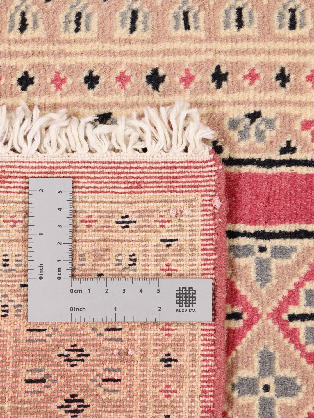 A set of two hand-knotted Pakistan Bokhara Wool rugs in red and beige tones.
