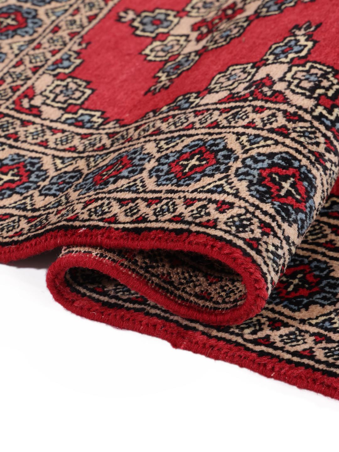 Hand-knotted Pakistan Bokhara rug in red with geometric motifs