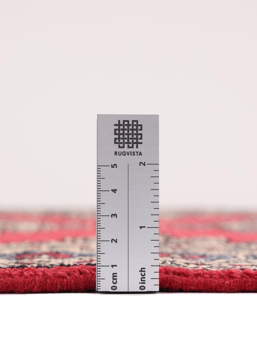Hand-knotted Pakistan Bokhara rug in red with geometric motifs