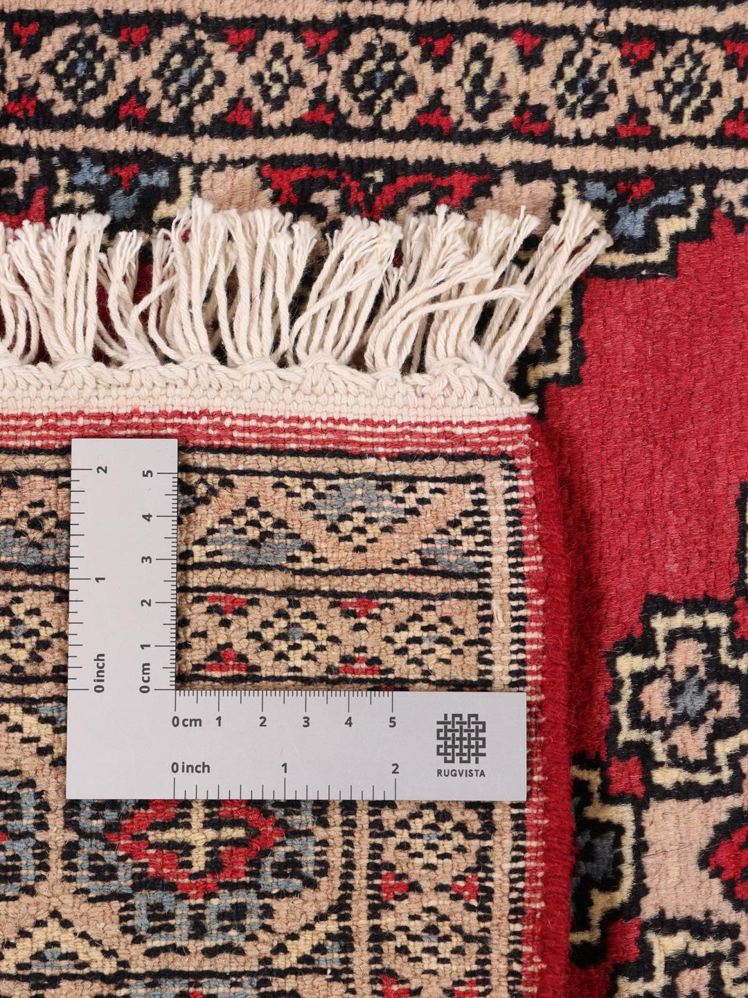 Hand-knotted Pakistan Bokhara rug in red with geometric motifs