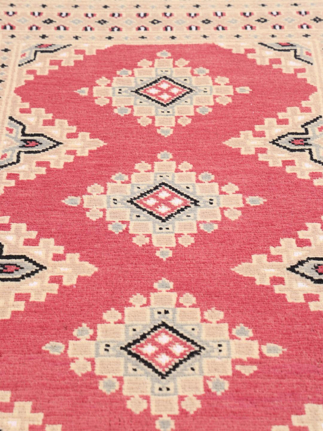 Hand-knotted Pakistan Bokhara 2ply rug with a red field and geometric patterns