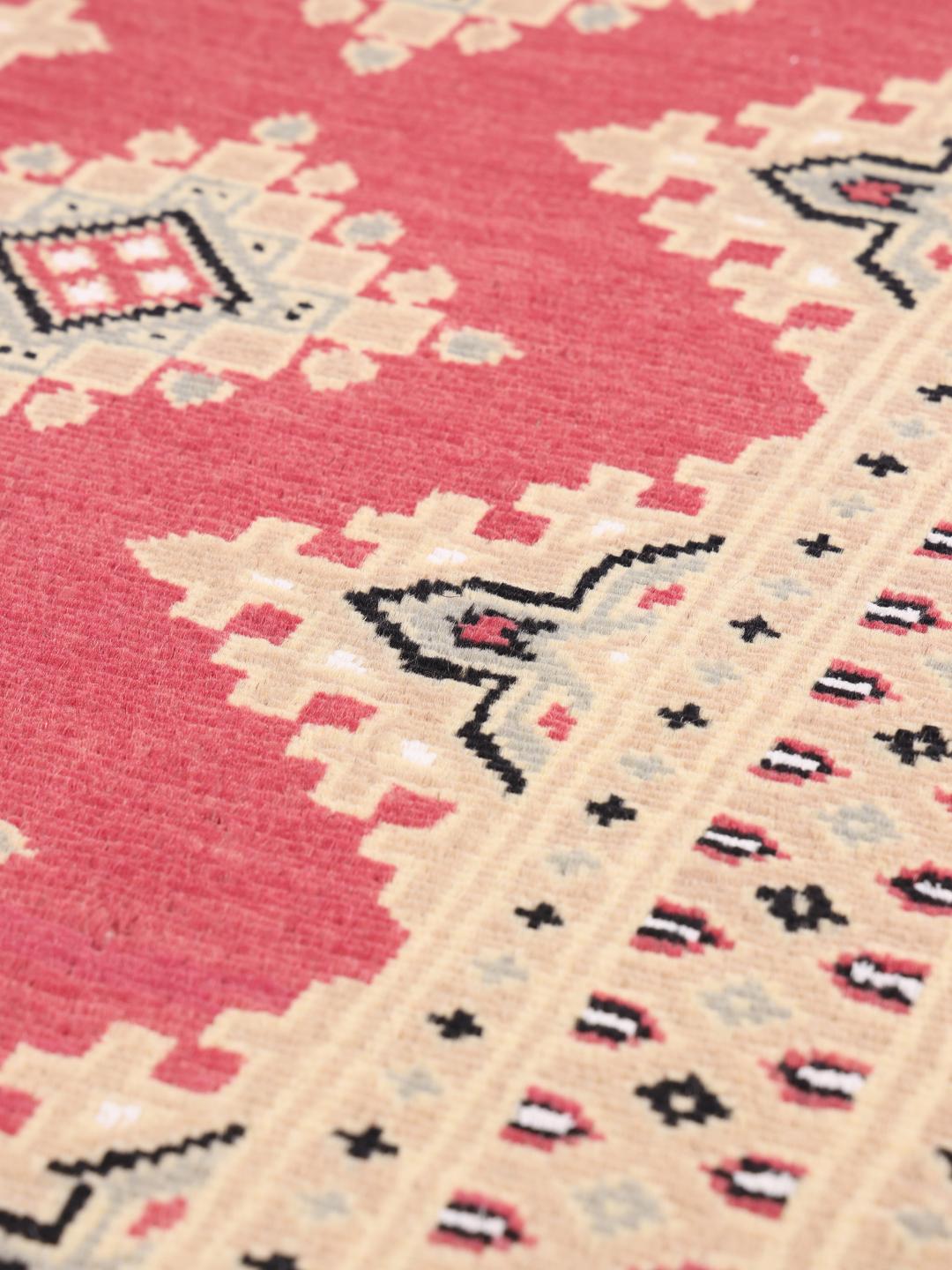 Hand-knotted Pakistan Bokhara 2ply rug with a red field and geometric patterns