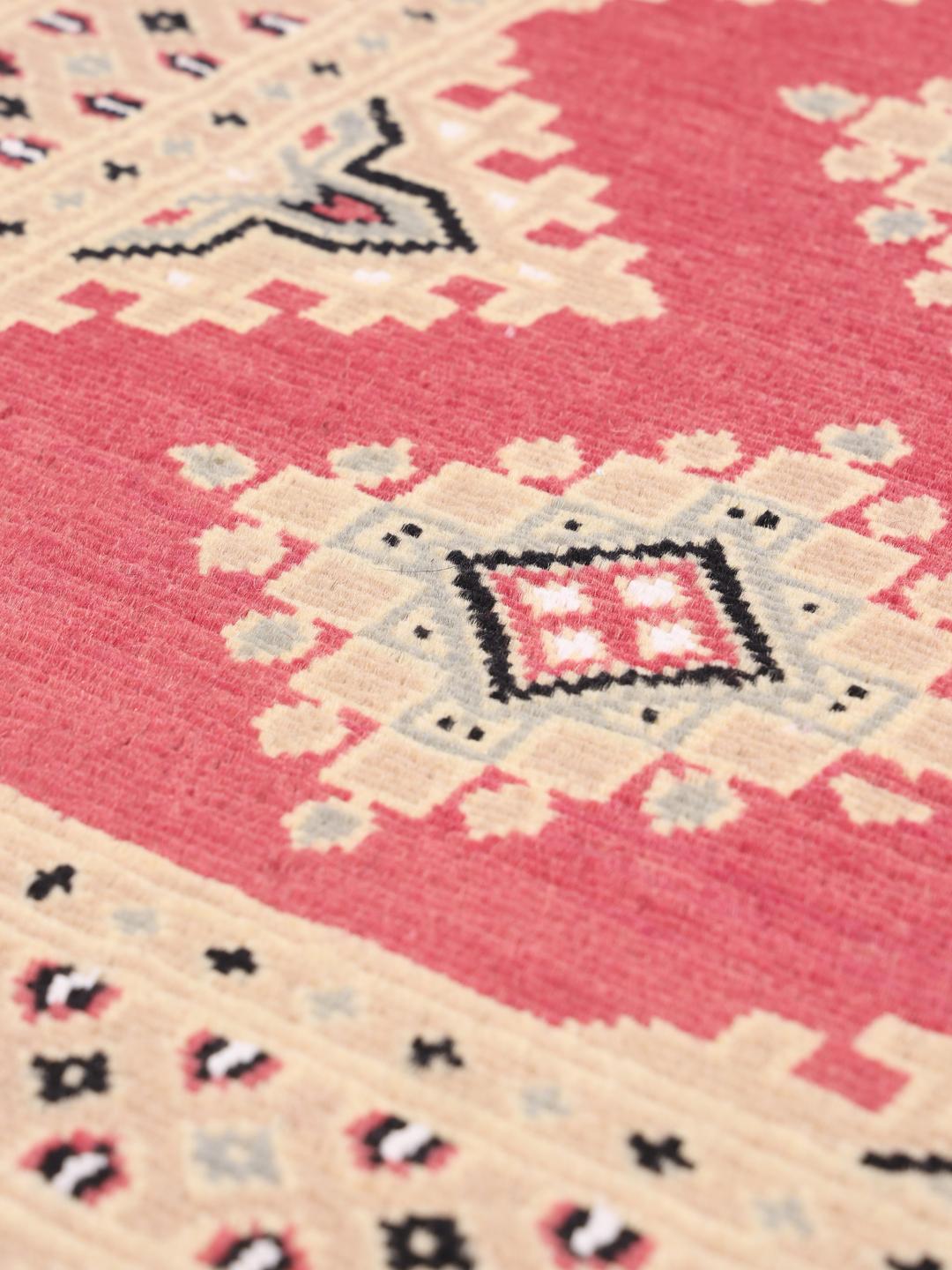 Hand-knotted Pakistan Bokhara 2ply rug with a red field and geometric patterns