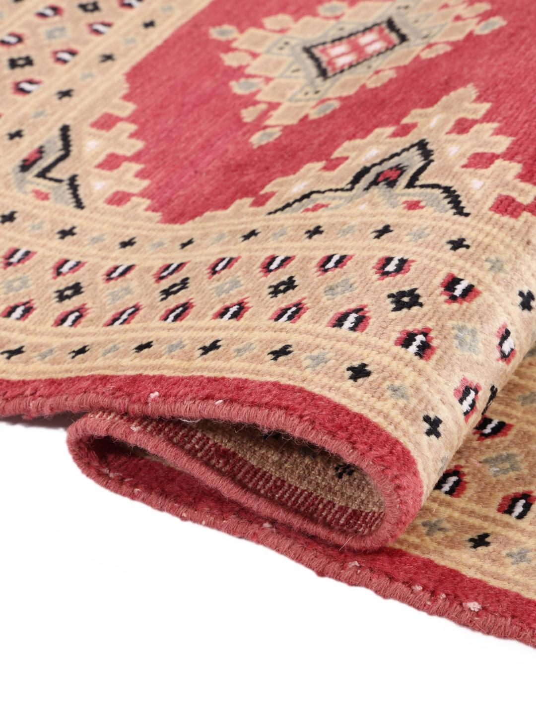 Hand-knotted Pakistan Bokhara 2ply rug with a red field and geometric patterns