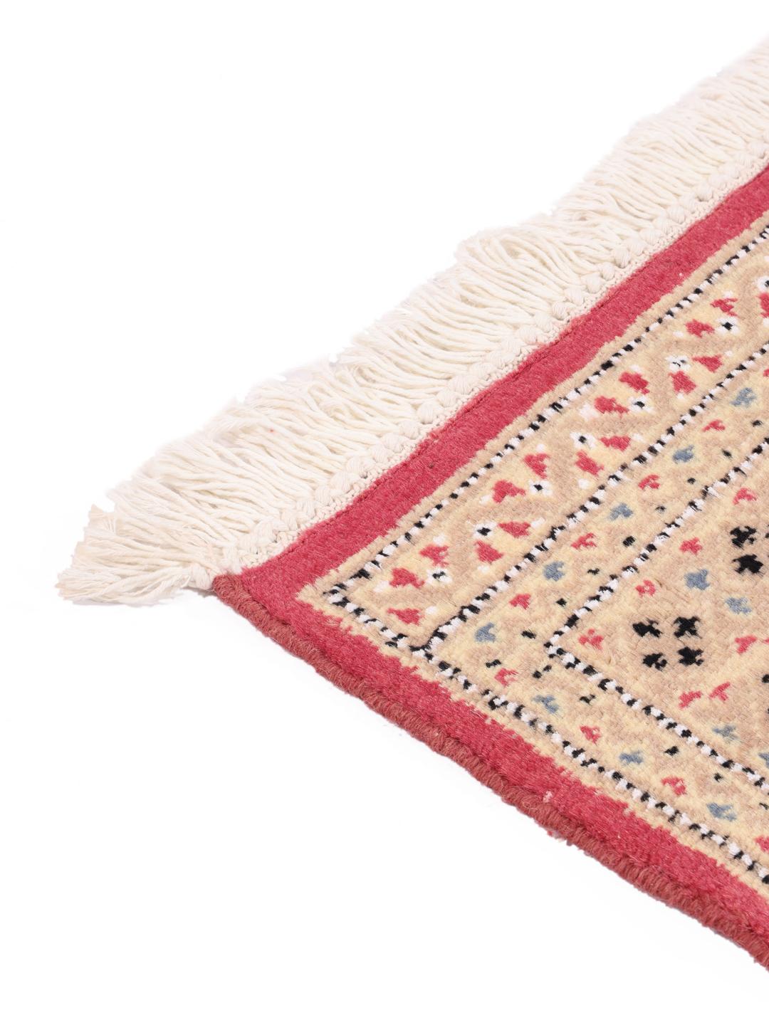A set of two rectangular hand-knotted red Pakistan Bokhara rugs with intricate geometric patterns