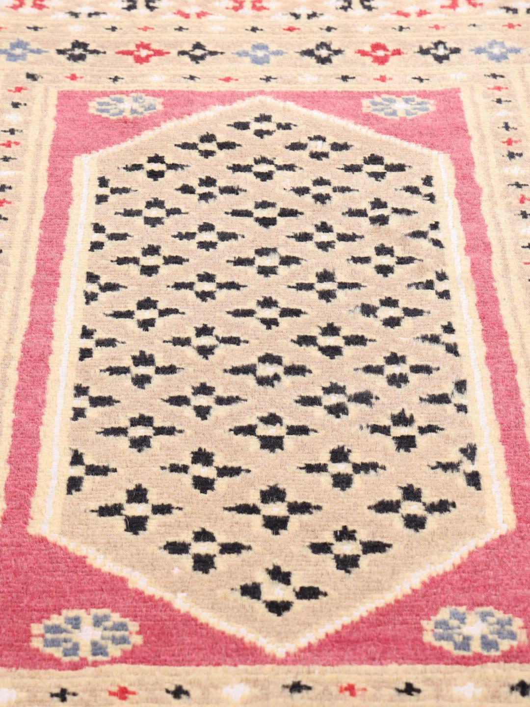 A set of two rectangular hand-knotted red Pakistan Bokhara rugs with intricate geometric patterns