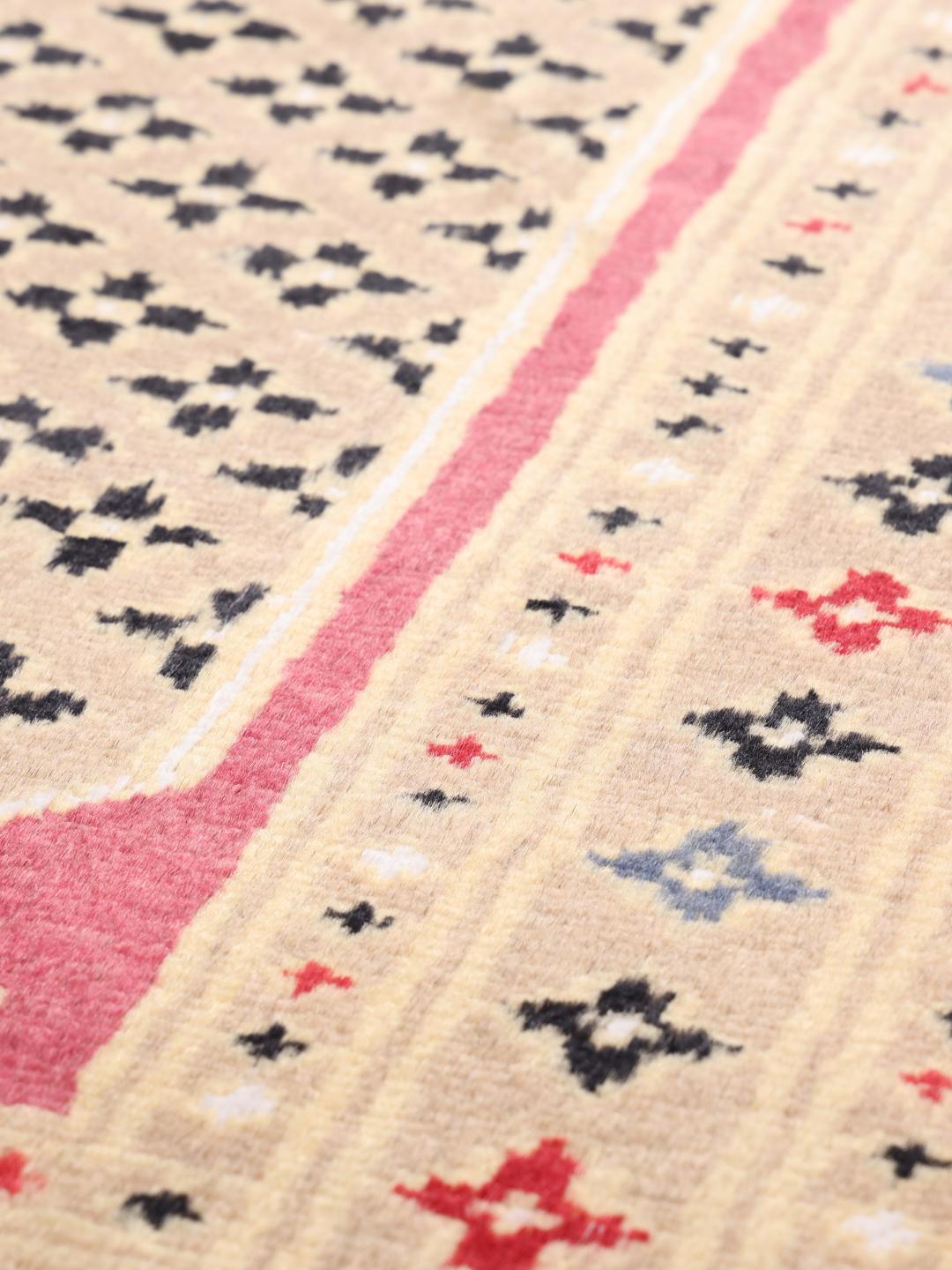 A set of two rectangular hand-knotted red Pakistan Bokhara rugs with intricate geometric patterns