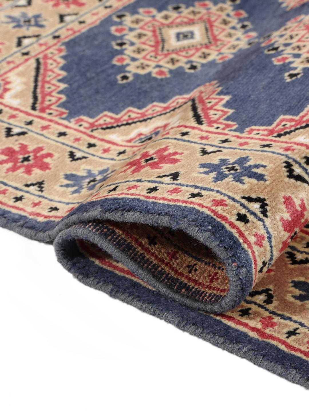 Hand-knotted wool rug from Pakistan in red and blue tones