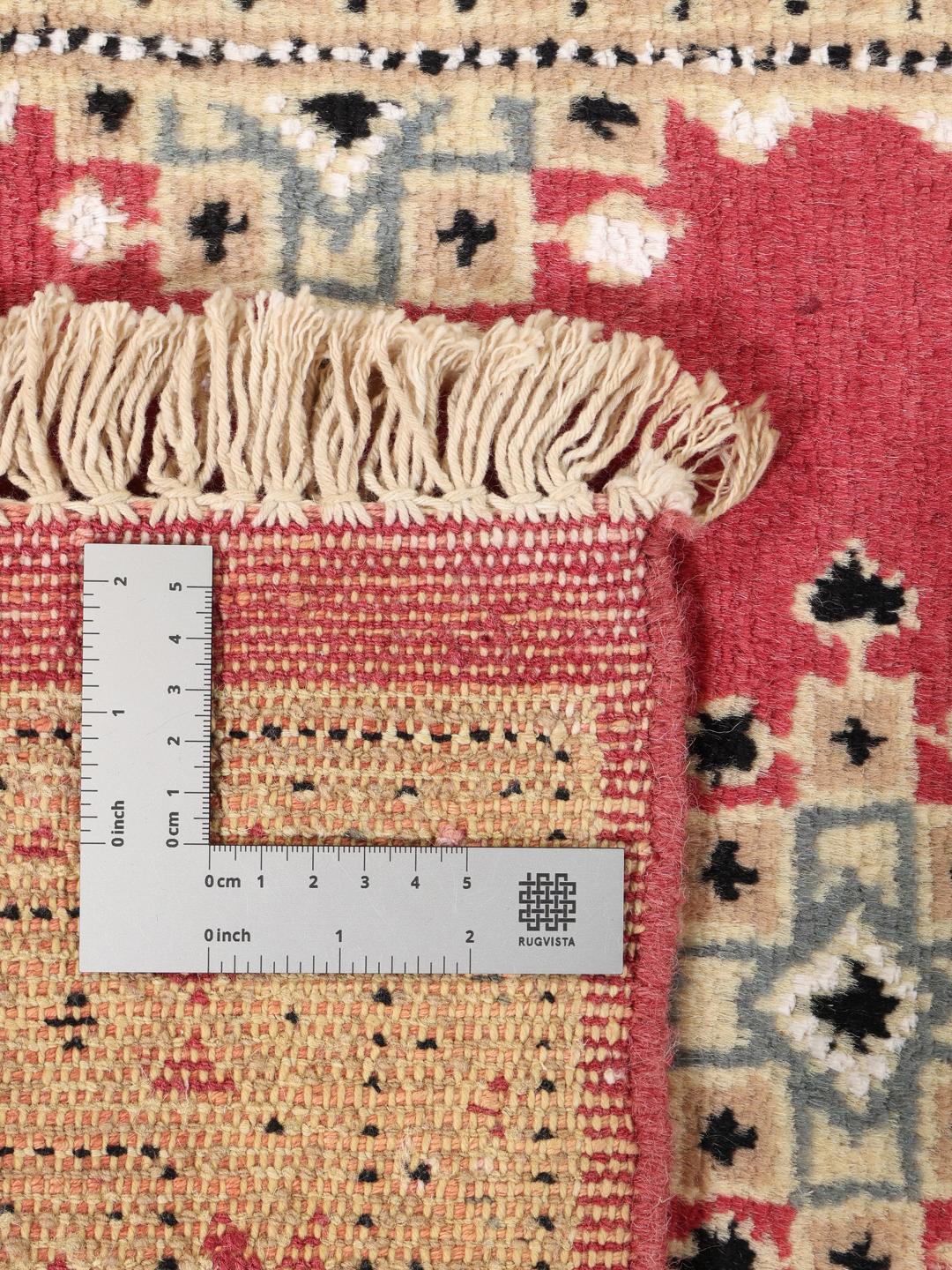 Hand-knotted wool rug from Pakistan in red and blue tones