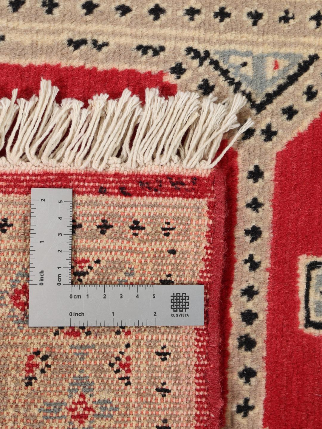 A hand-knotted Pakistan Bokhara 2ply rug with a red field and geometric motifs.