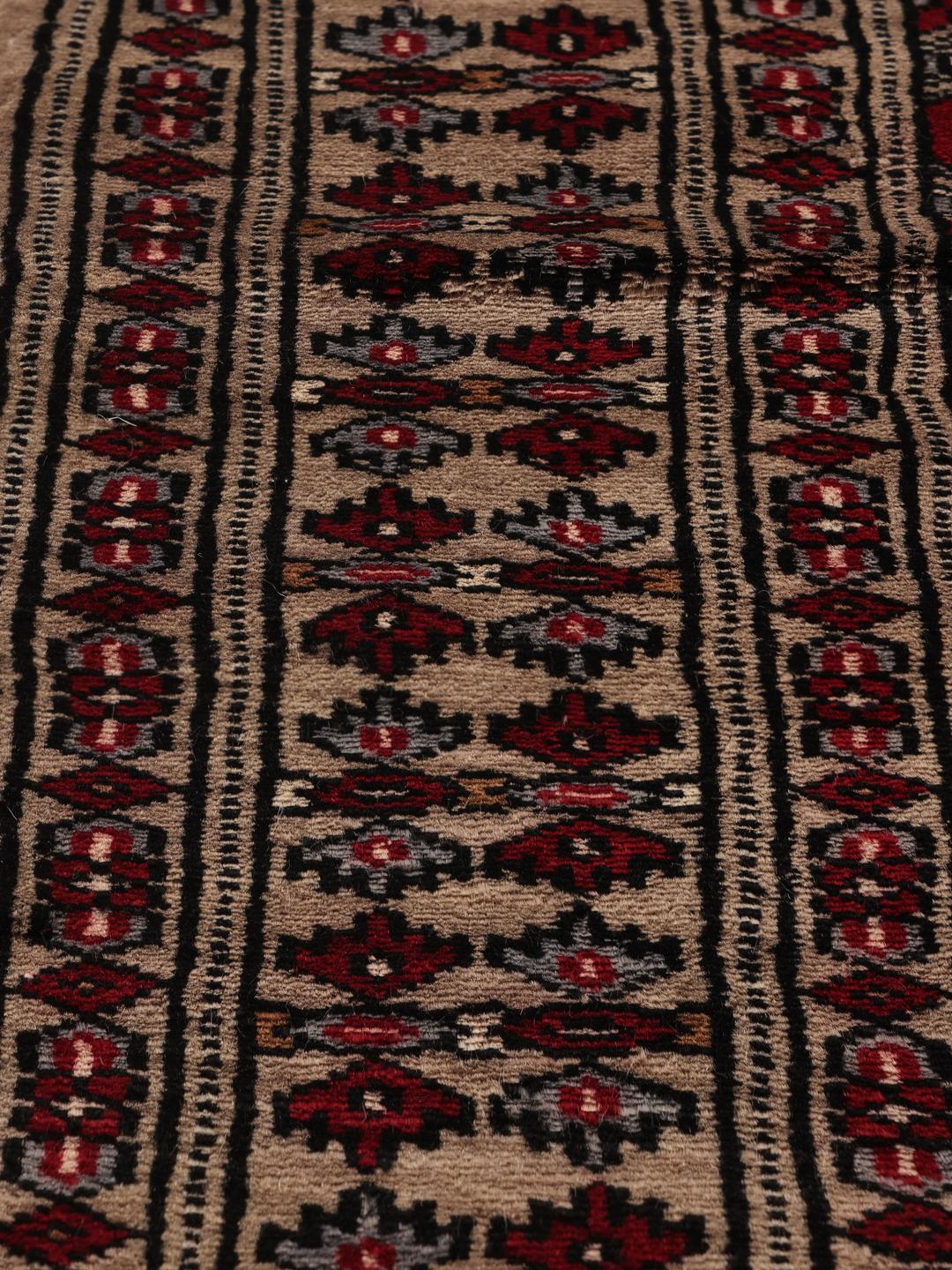 Hand-knotted Pakistan Bokhara rug with a red field and geometric motifs