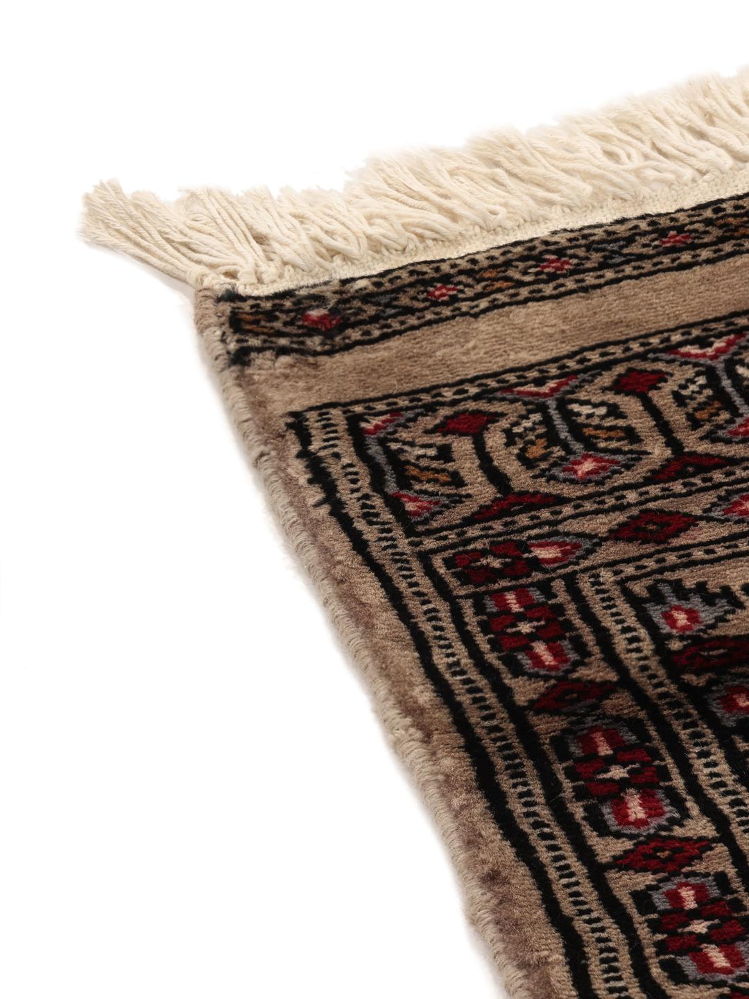 Hand-knotted Pakistan Bokhara rug with a red field and geometric motifs