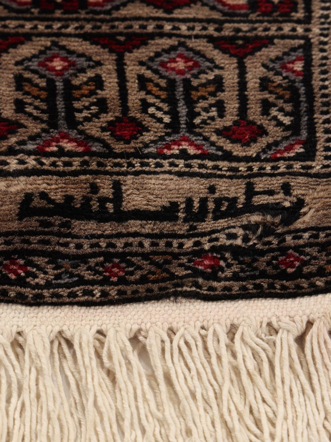 Hand-knotted Pakistan Bokhara rug with a red field and geometric motifs