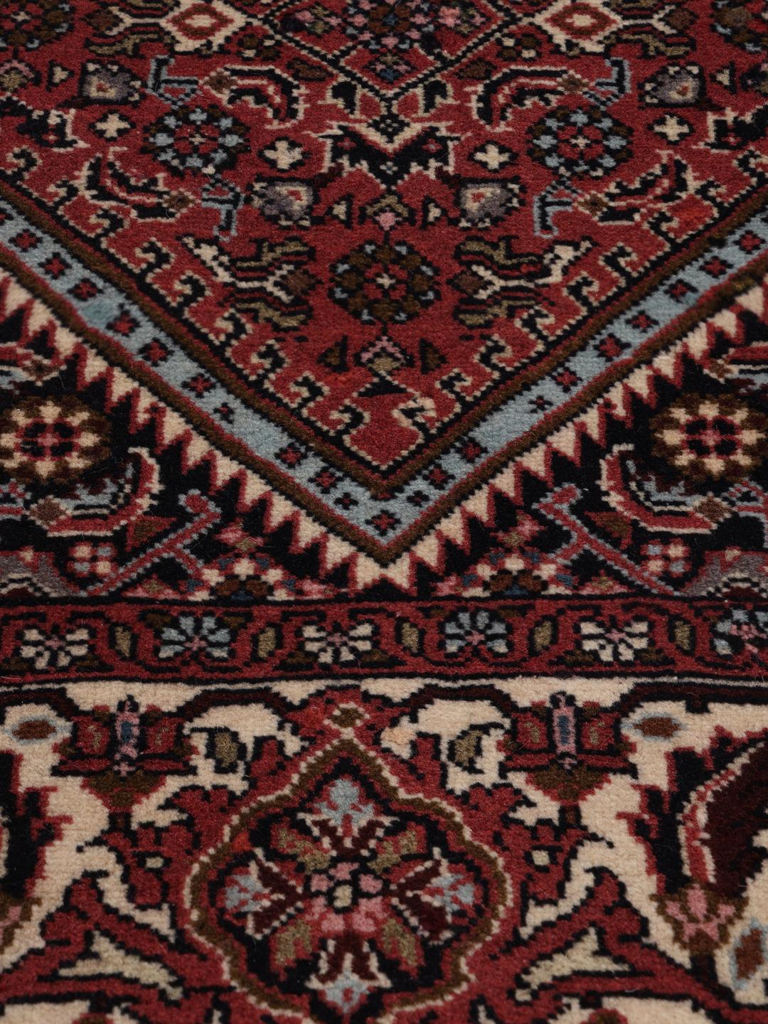 A hand-knotted Bidjar rug from the Middle East in deep red tones.