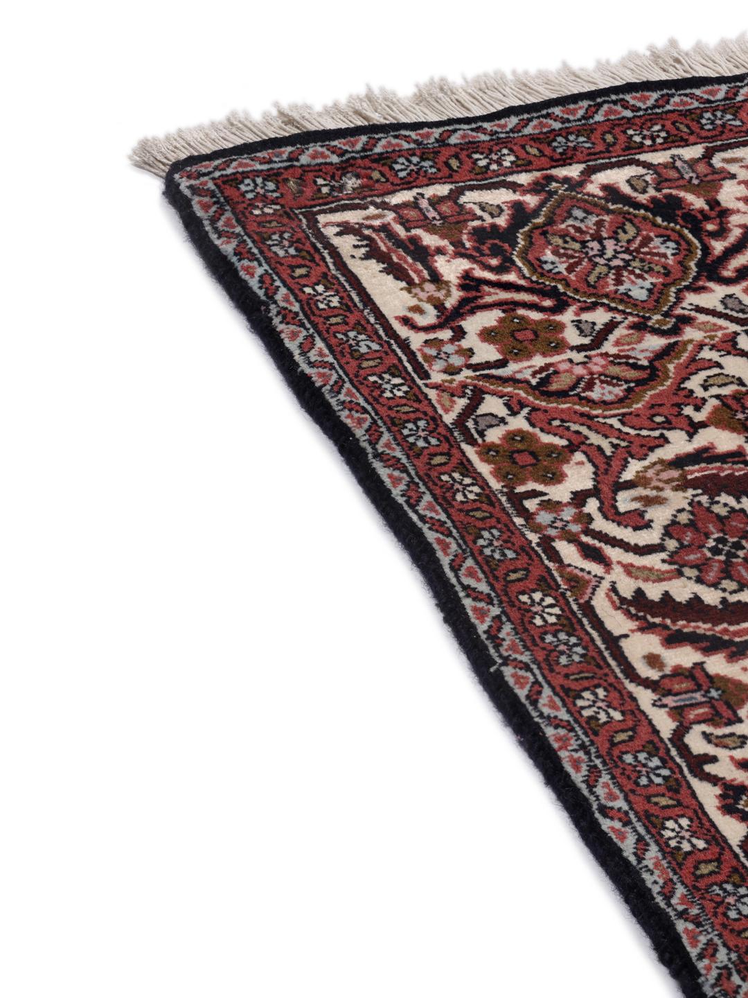 A hand-knotted Bidjar rug from the Middle East in deep red tones.