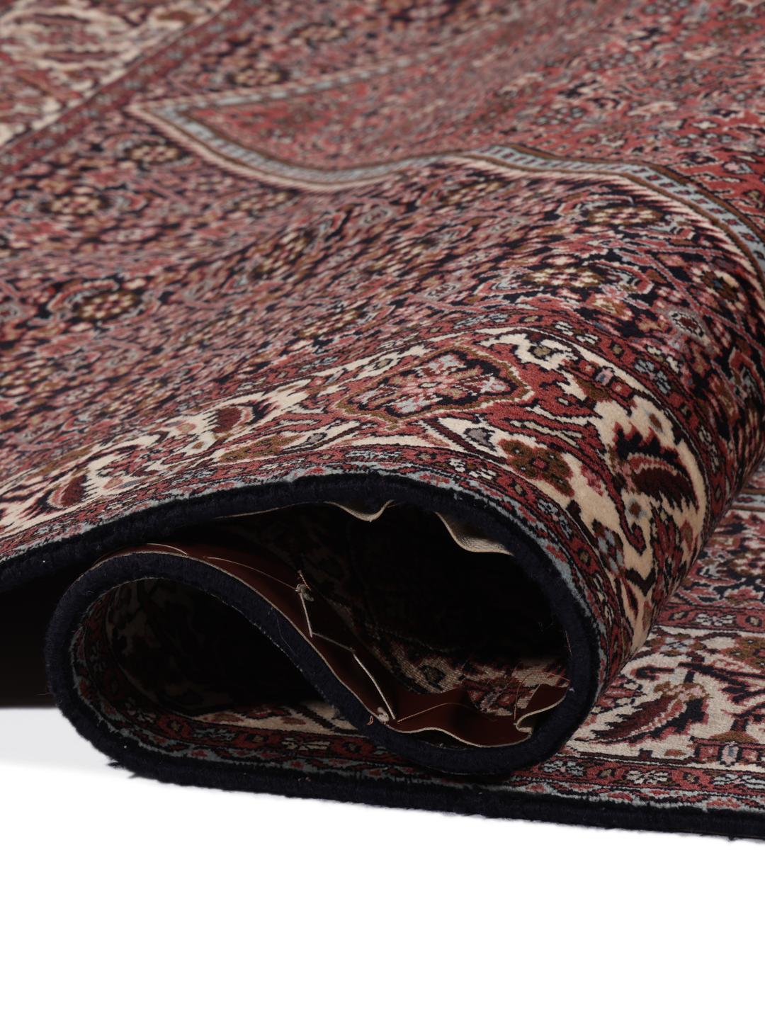 A hand-knotted Bidjar rug from the Middle East in deep red tones.