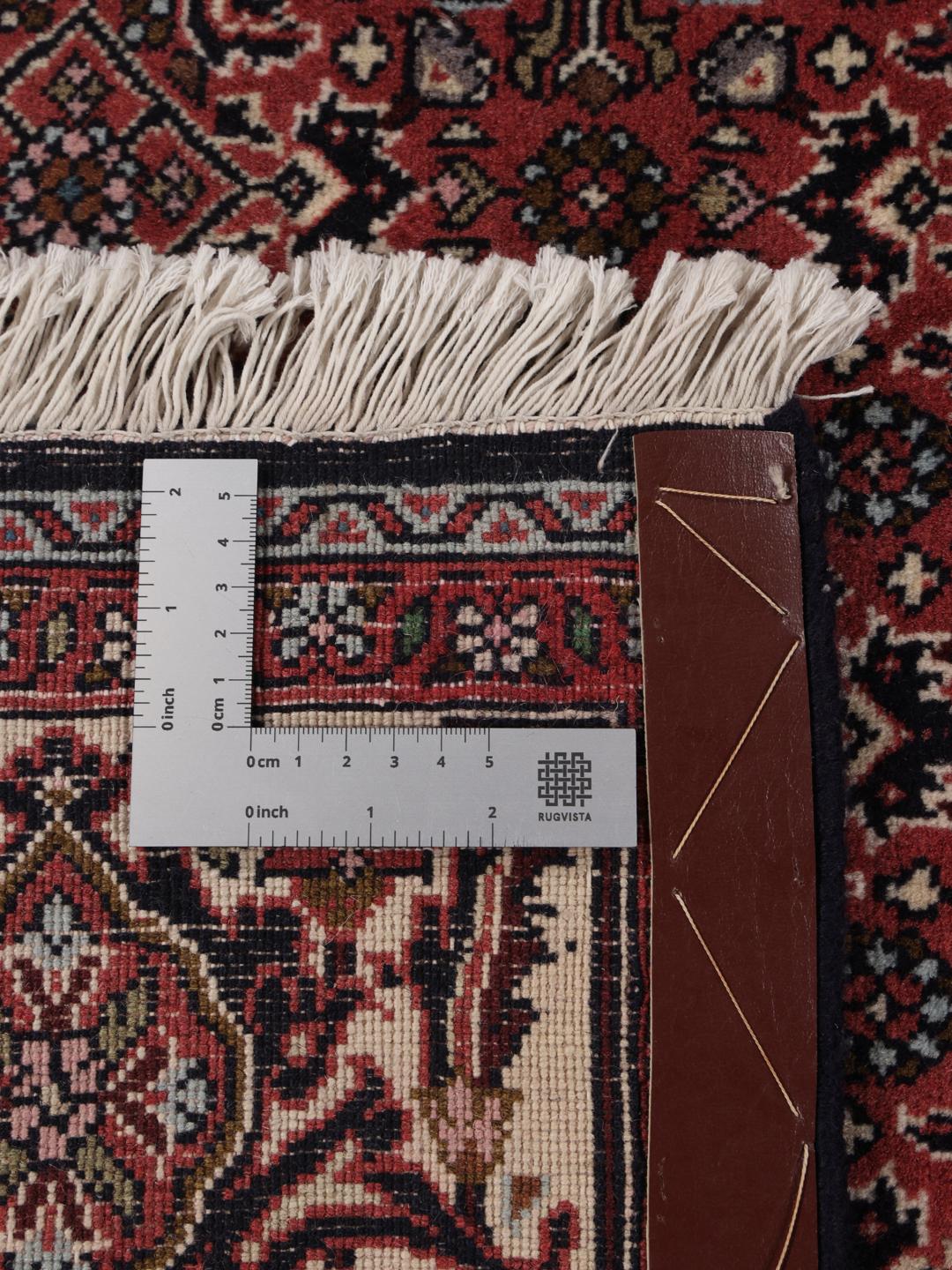 A hand-knotted Bidjar rug from the Middle East in deep red tones.