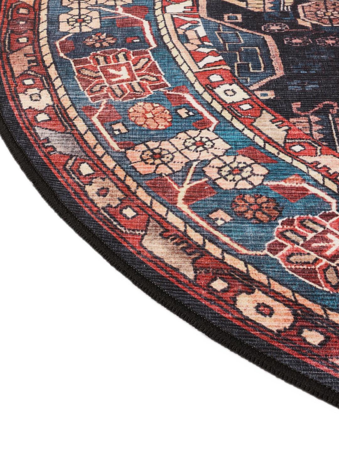 Round rug in blue and black with intricate Oriental patterns