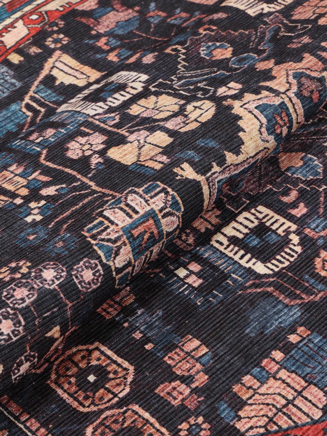 Round rug in blue and black with intricate Oriental patterns