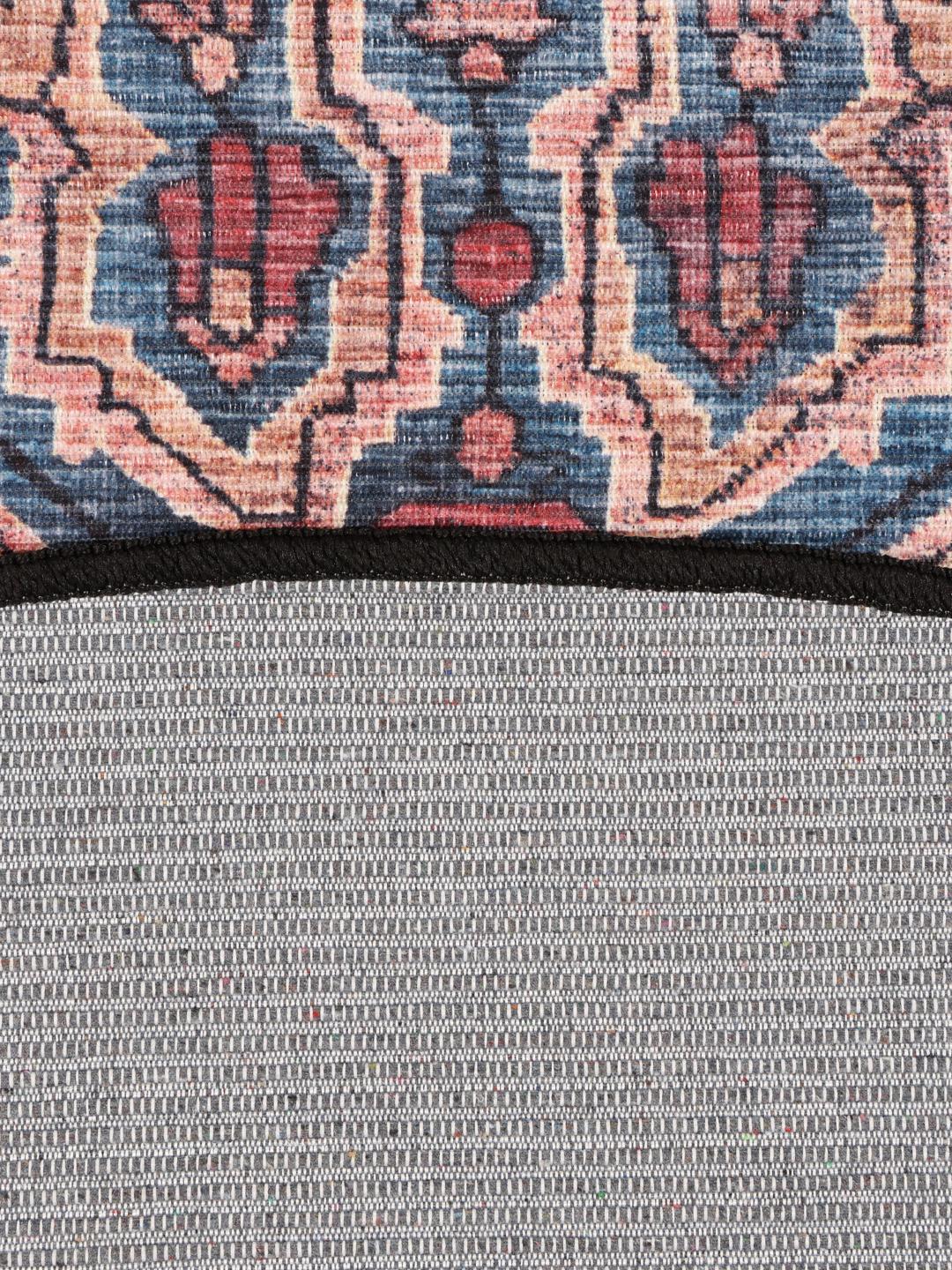 Round rug in blue and black with intricate Oriental patterns