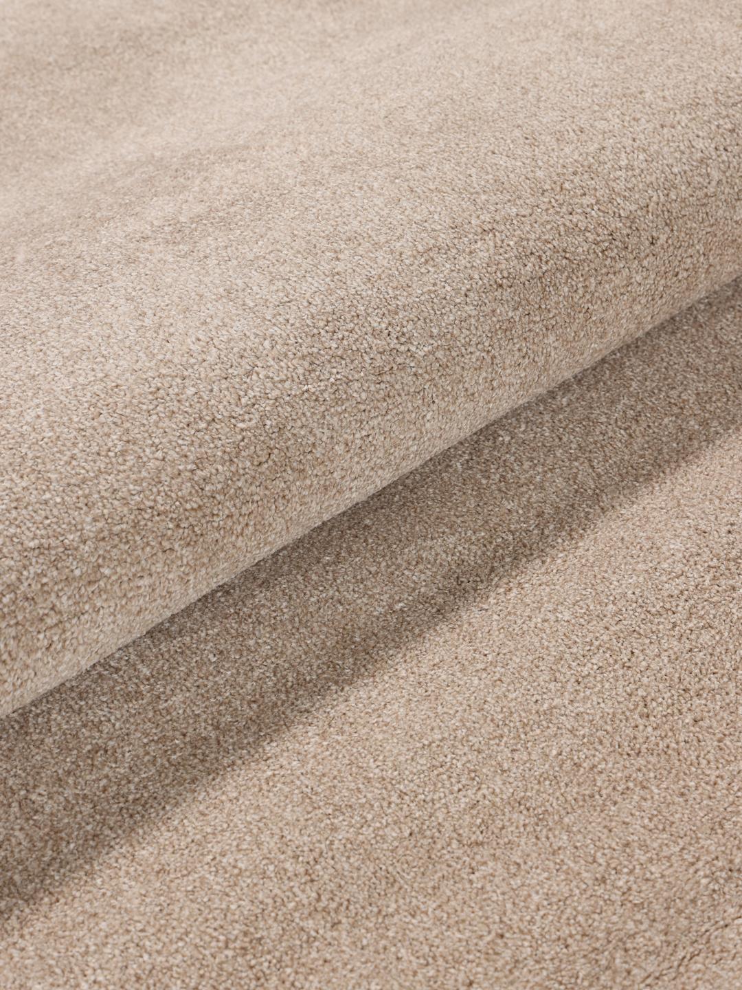 Round beige rug