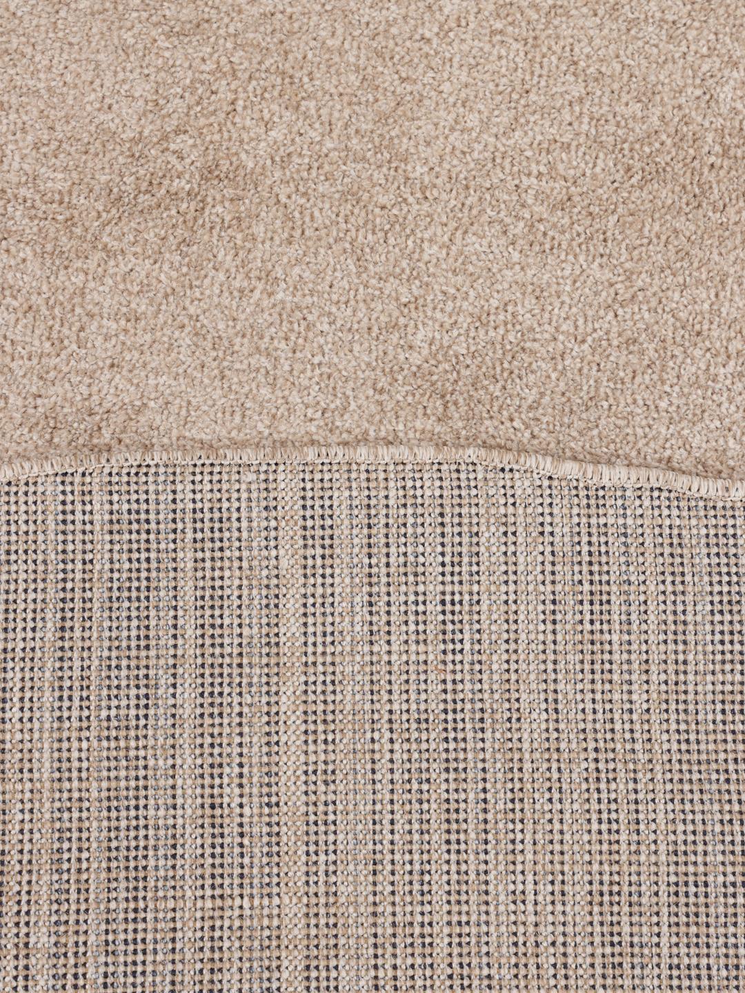 Round beige rug