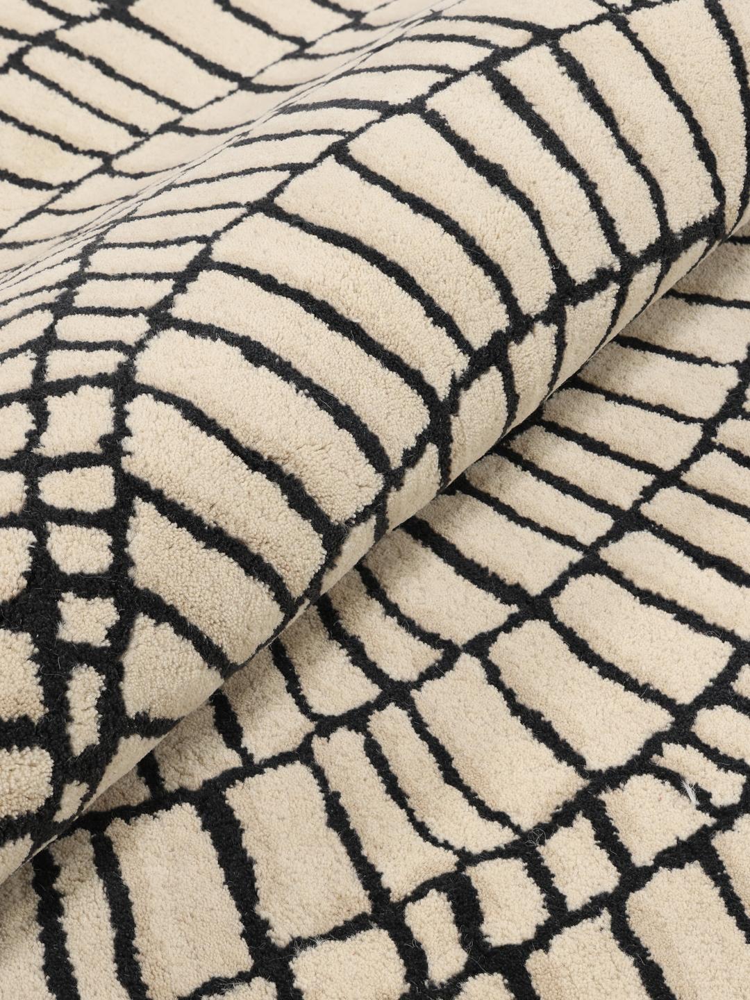 Rond beige en zwart tapijt