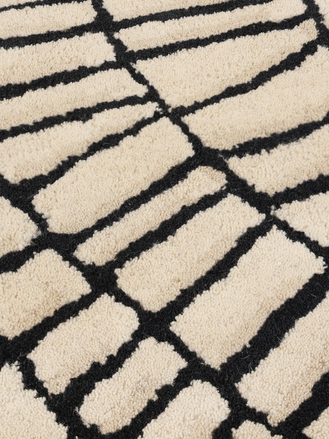 Rond beige en zwart tapijt