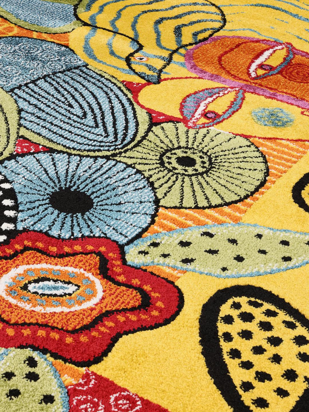 Et flerfarvet tæppe med et kunstnerisk blomster- og karakterdesign